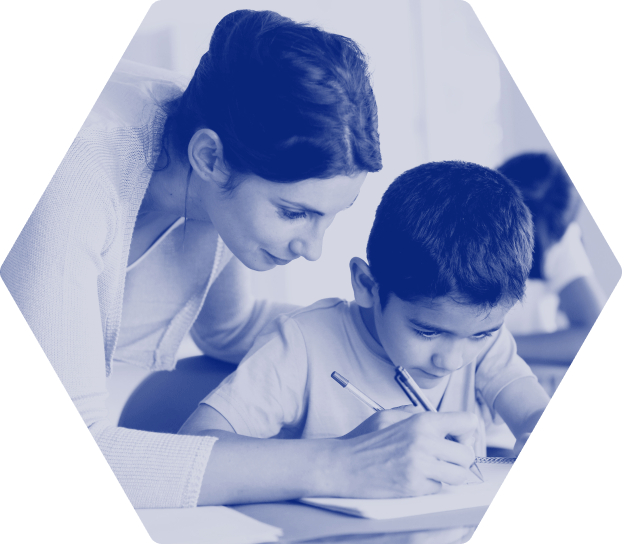 Woman leaning over child's shoulder helping him write